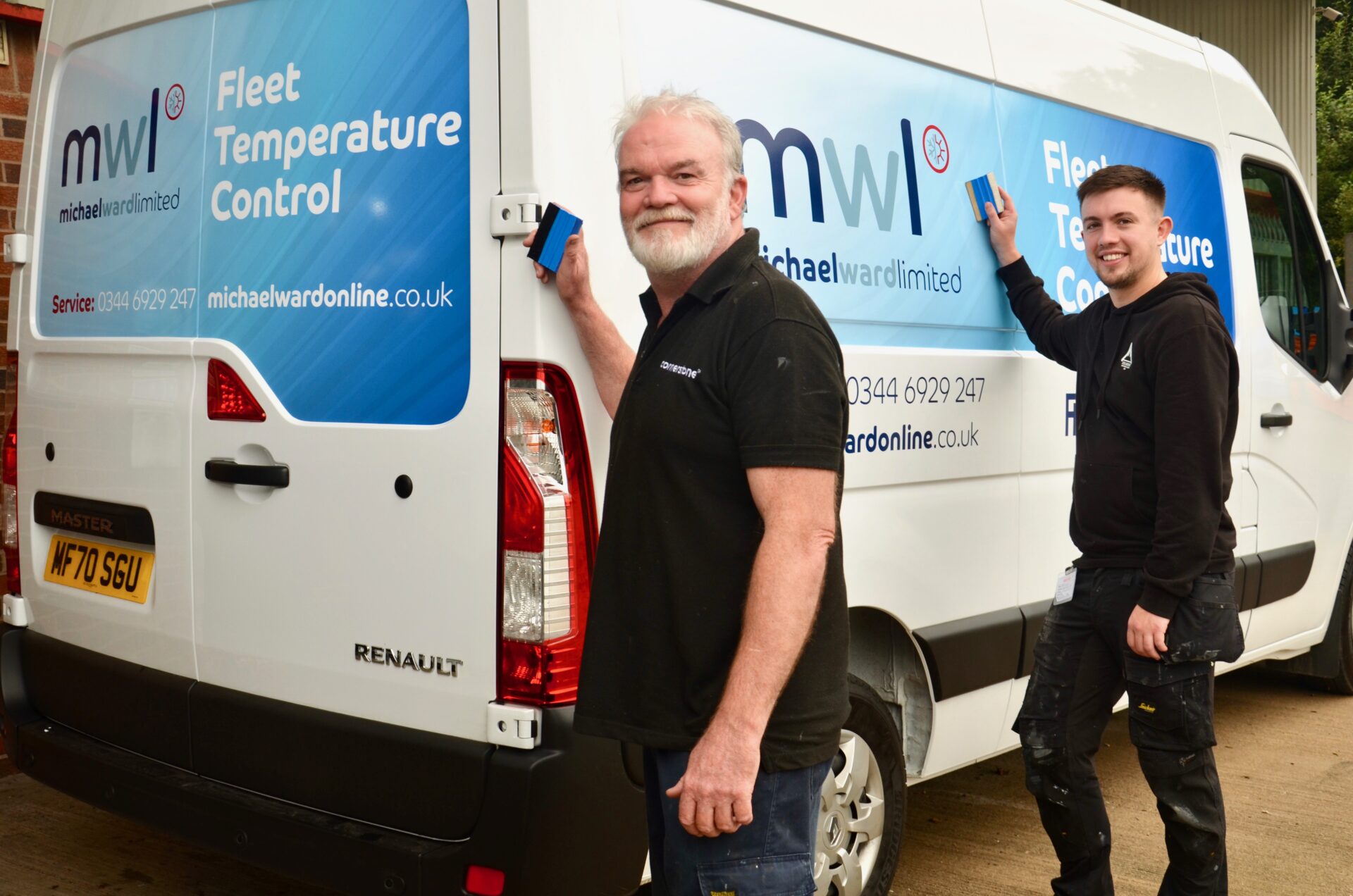 signage team applying wrap to van