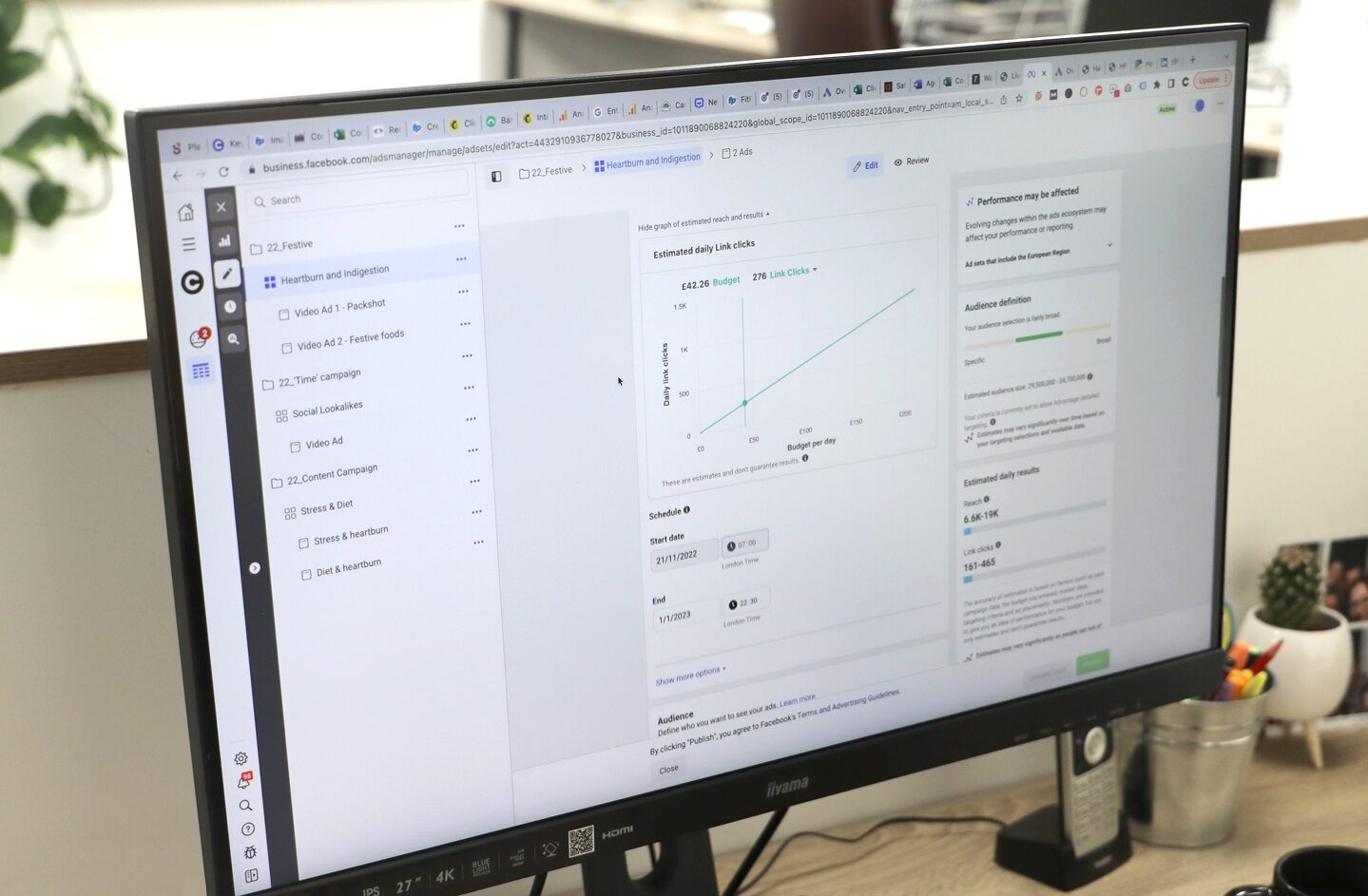 Computer screen at a desk - showing the projected impressions of a paid social campaign on Facebook